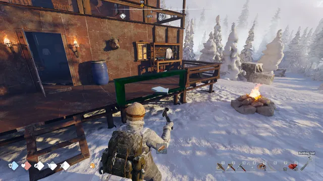 Permafrost survivor using the building tool in a workshop and campfire area